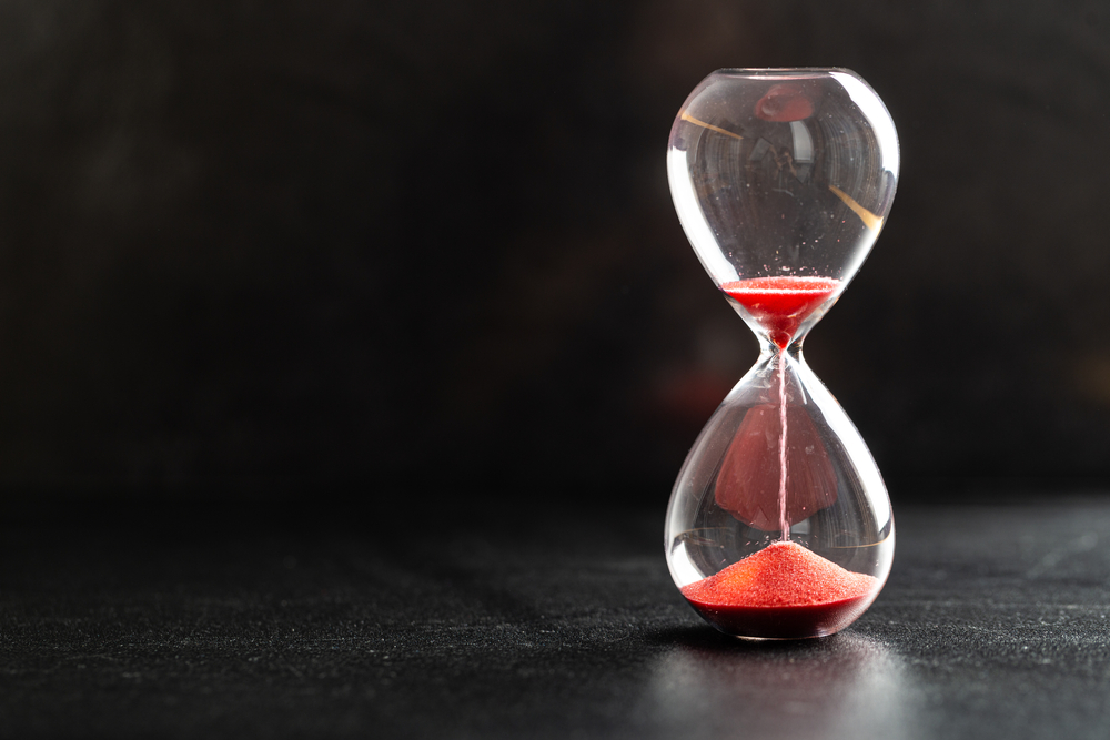 Sand passes through hourglass bulbs measuring the transit time
