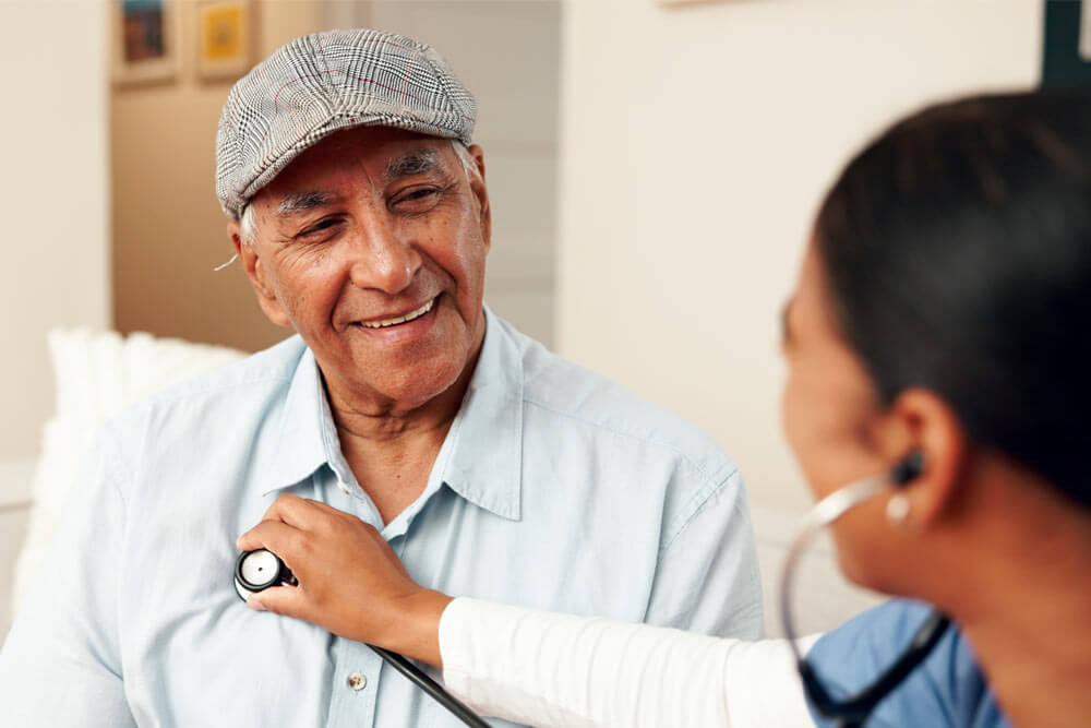 Smile, senior man and nurse with stethoscope