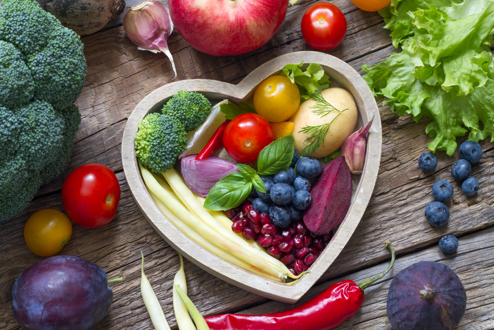 Healthy food in heart diet cooking concept with fresh fruits and vegetables