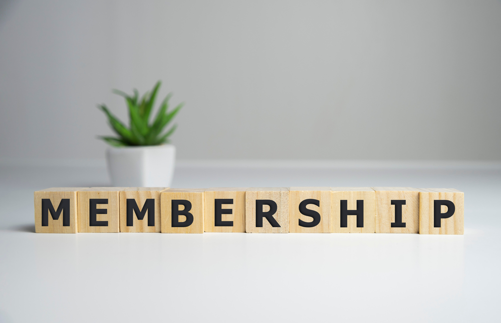 focus on wooden blocks with letters making Membership text
