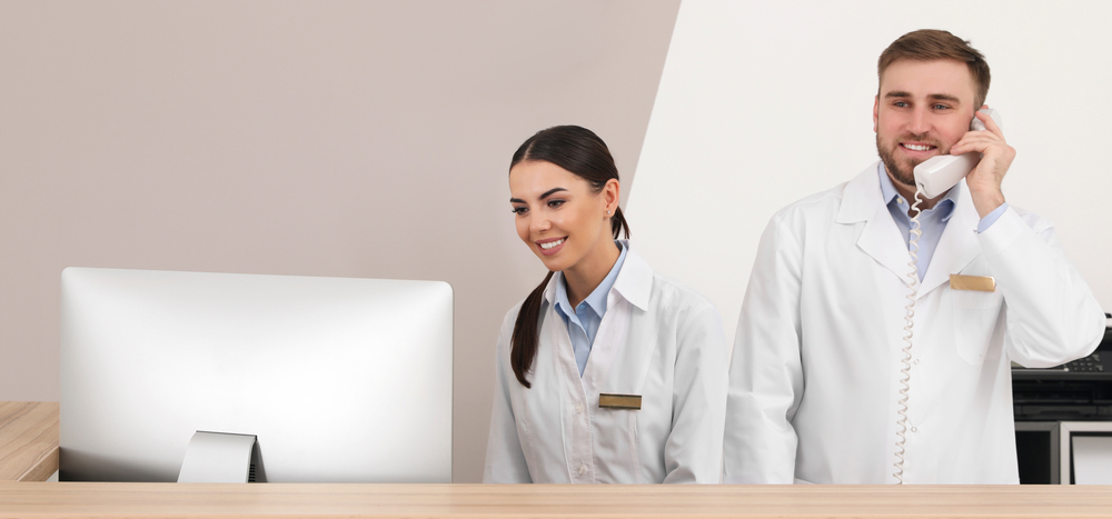 Professional staff working at reception in modern clinic