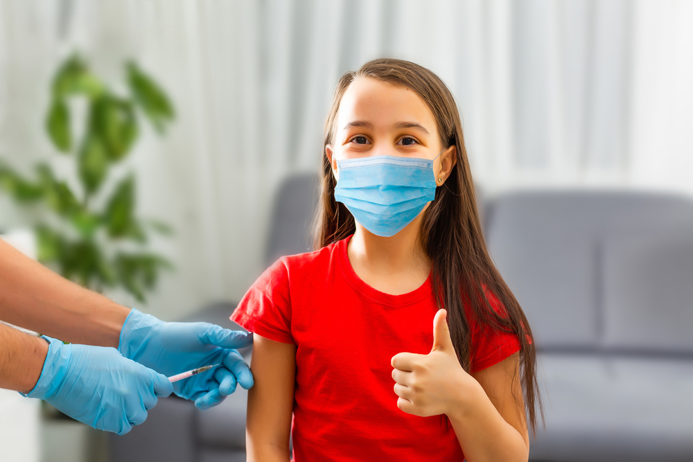 Little girl receiving vaccination in clinic, closeup. virus prevention