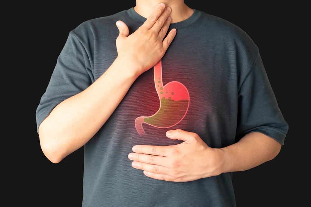 Man suffering from heartburn, stomachache, nausea and bloating