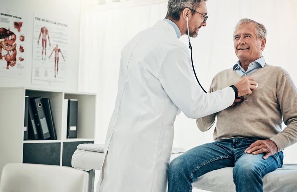 doctor checking patient's heart