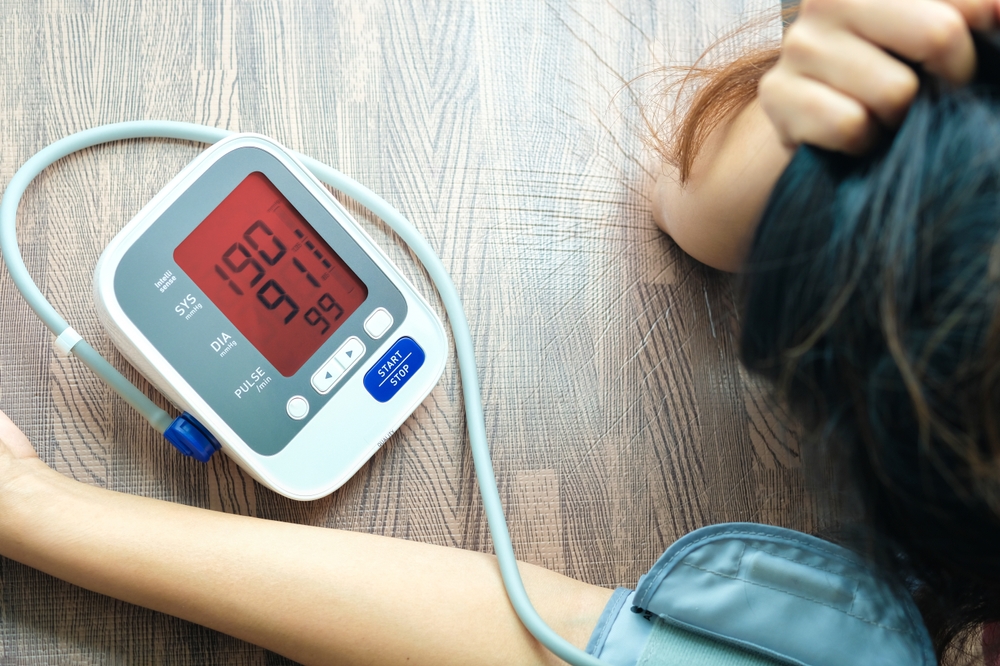 The woman is stressed and she has high blood pressure