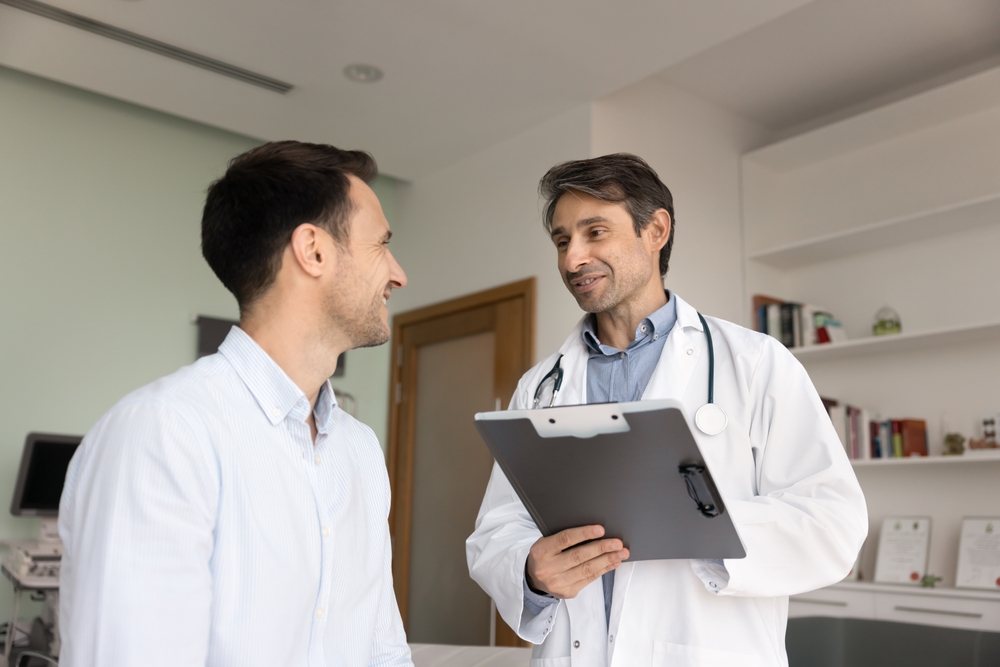 Positive optimistic Latin doctor giving consultation, recommendation to patient after checkup