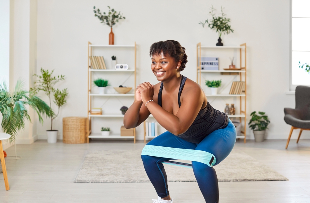 Happy young woman enjoying active exercise during sports workout at home