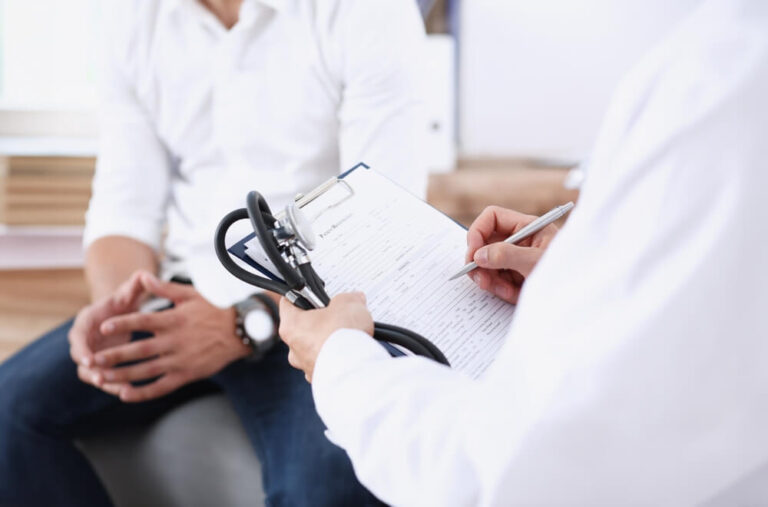 Male doctor hand hold silver pen and showing pad