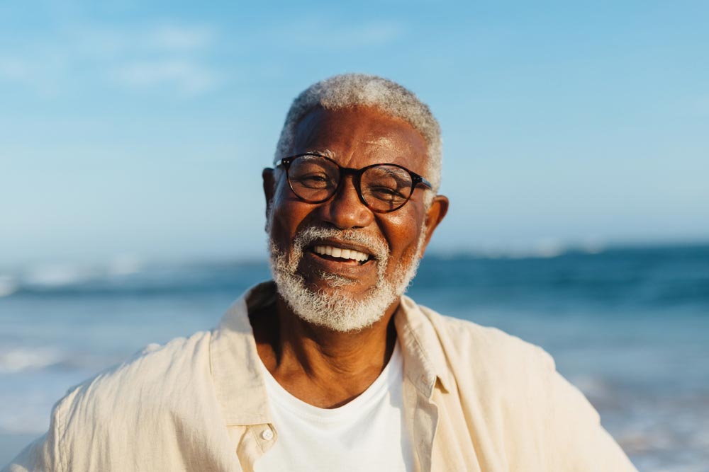A happy older man with glasses