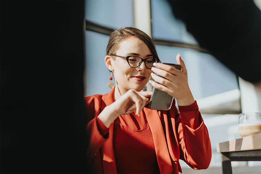 a woman with glasses using her phone