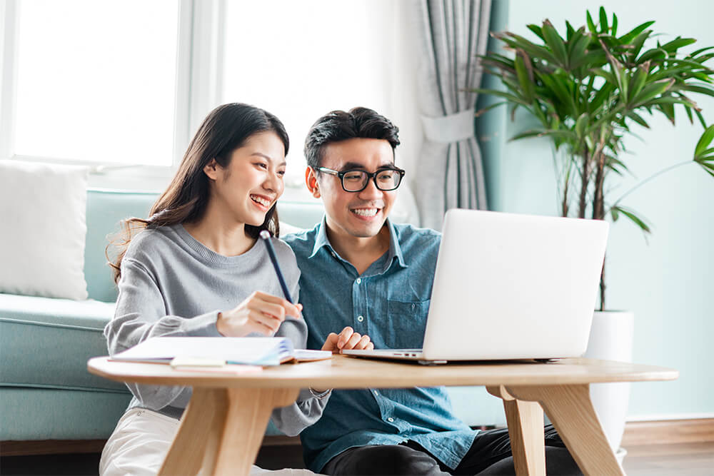 Young office workers man and woman working on laptop