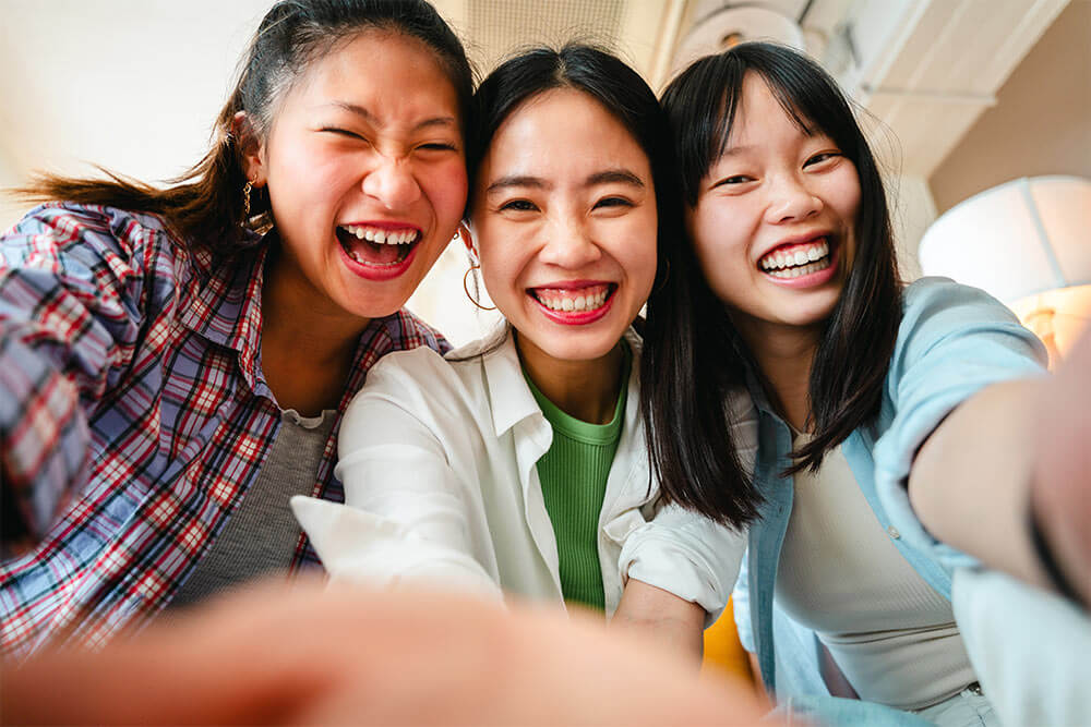 female asian friends laughing