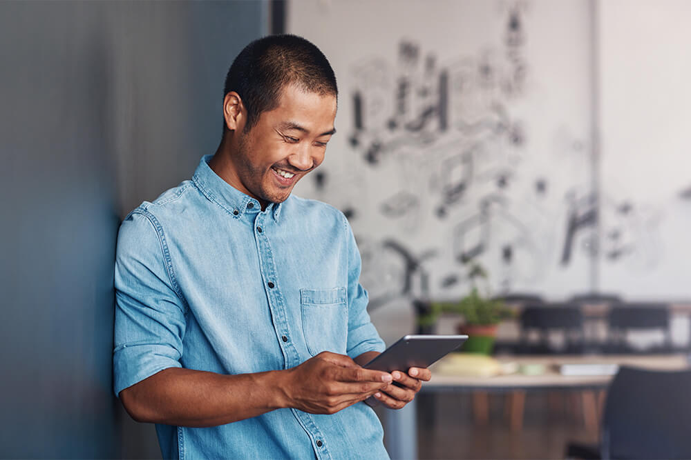 asian man holding tablet