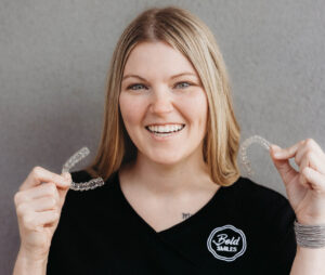 Brooklyn Buckner holding clear aligners