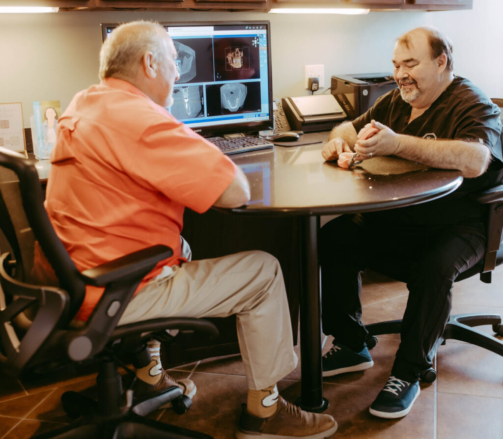 Dr. Jason Bolding talking to male patient