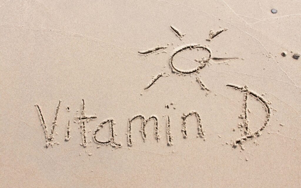 Vitamin D written in the sand