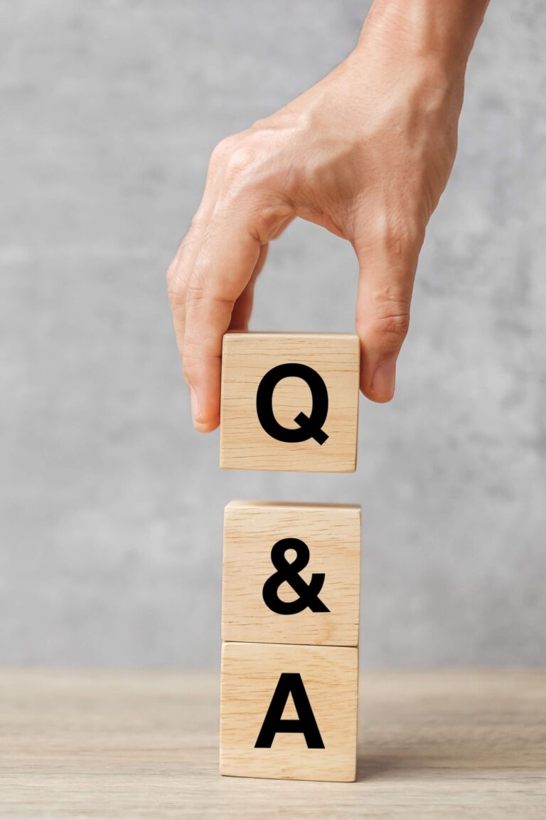 Hand holding Q and A word with wooden block