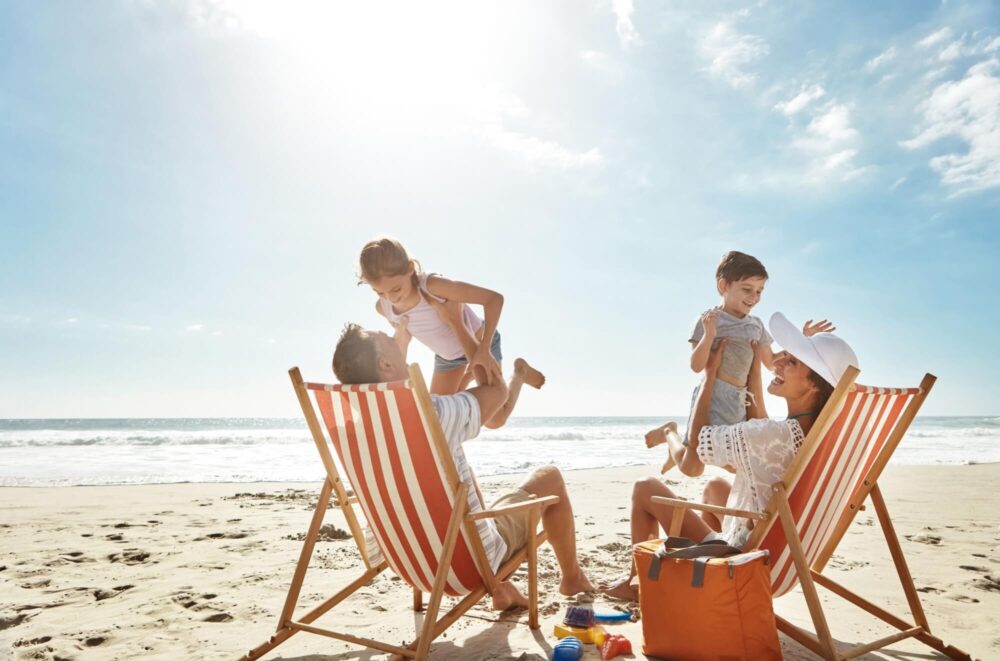 Family, beach and kids relax chair vacation adventure, bonding and play game together on tropical summer