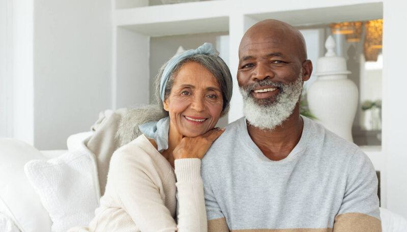 Older woman and man smiling at home