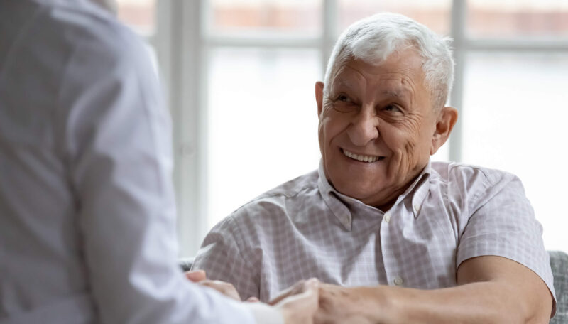 Older man smiling with medical doctor