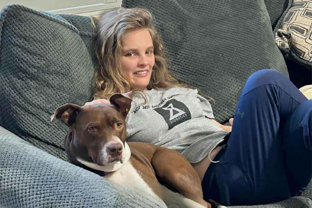 lora lying in the couch with a dog
