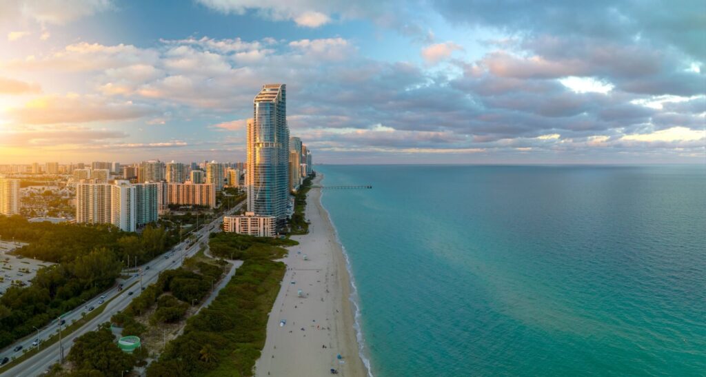 Expensive highrise hotels and condos over sandy beachfront on Atlantic ocean