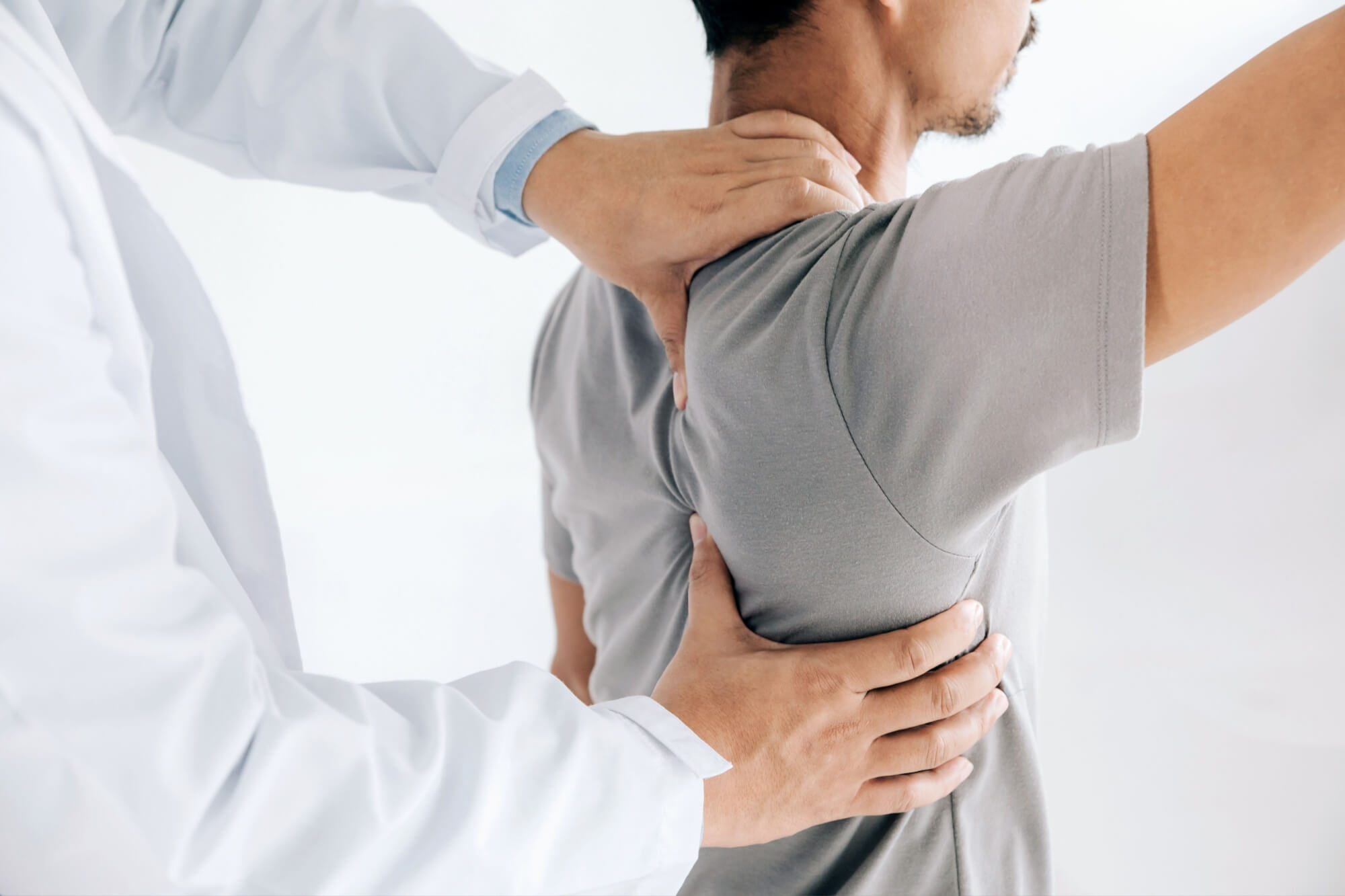 Physiotherapist doing healing treatment on man's back