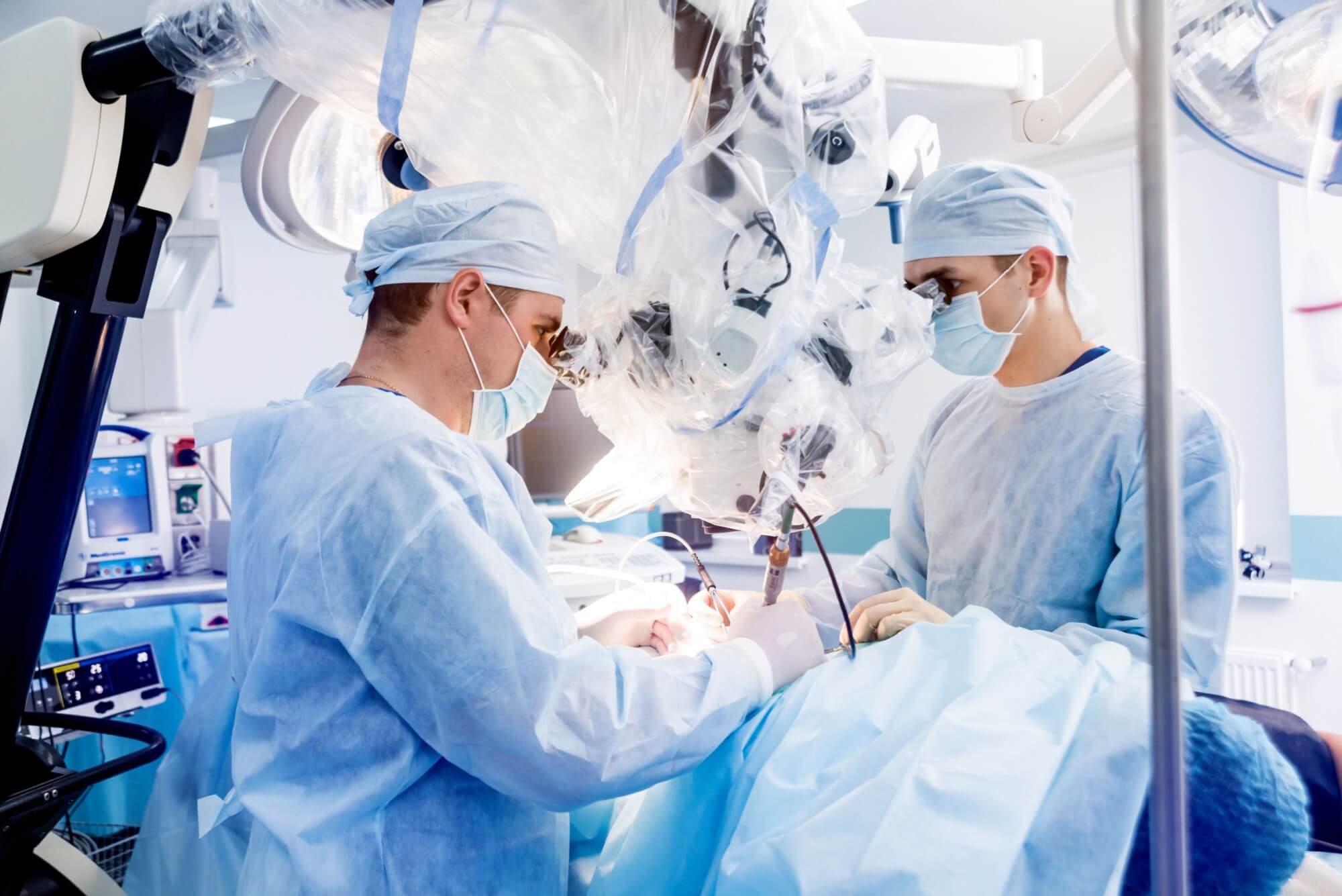 Spinal surgery. Group of surgeons in operating room with surgery equipment