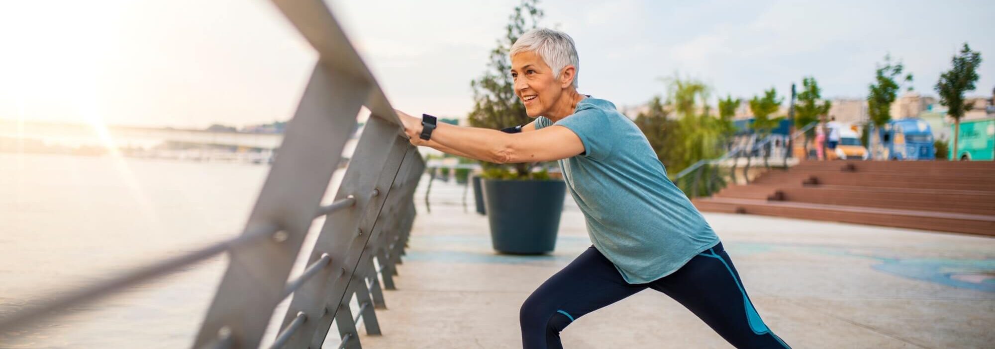 A senior woman stretches during her workout