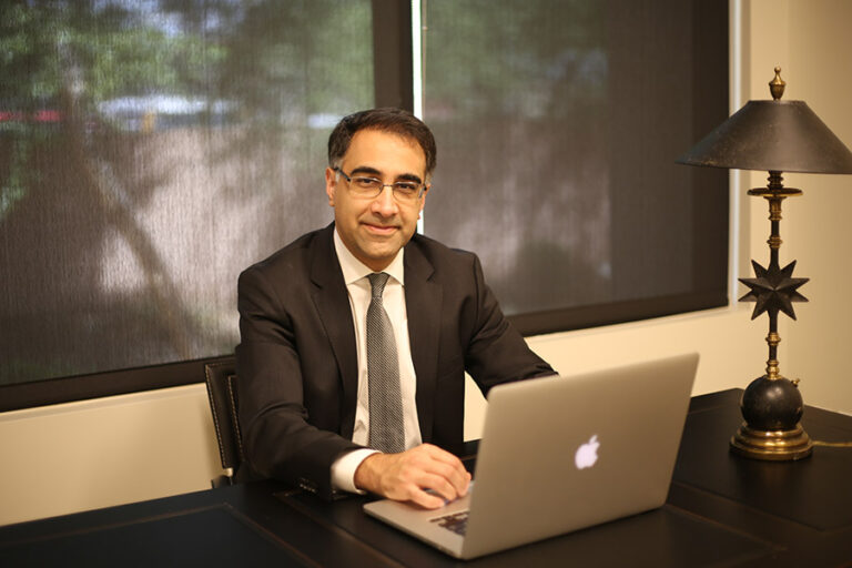 Dr. Azadi sitting at desk