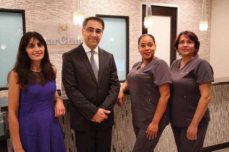 Dr. & Mrs. Azadi with staff at office reception desk