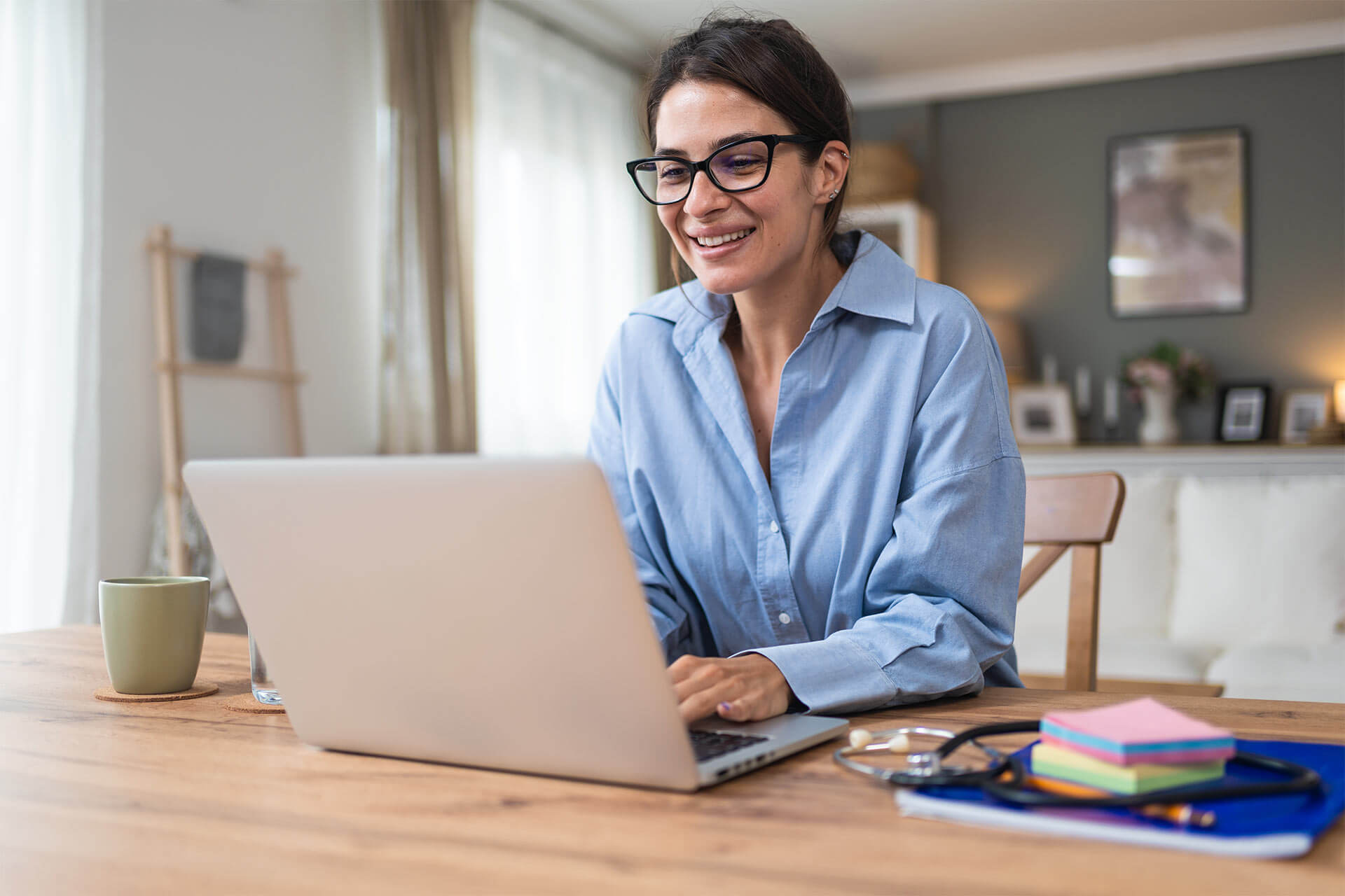 Telemedicine. Young woman doctor working at home office