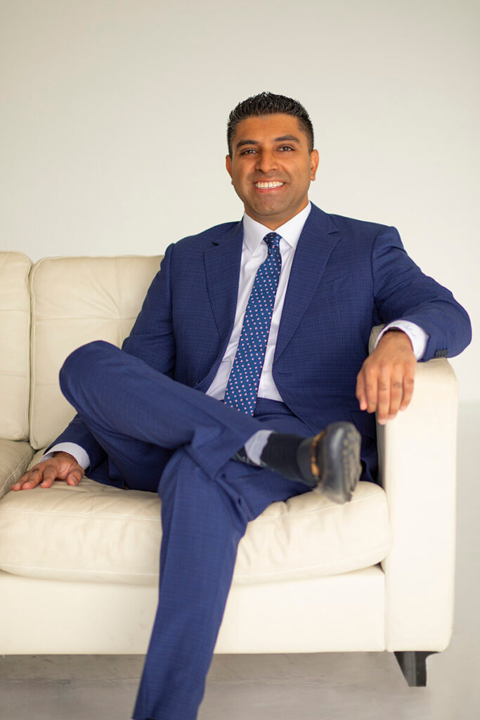 Dr Shah Blue Suit on Sofa