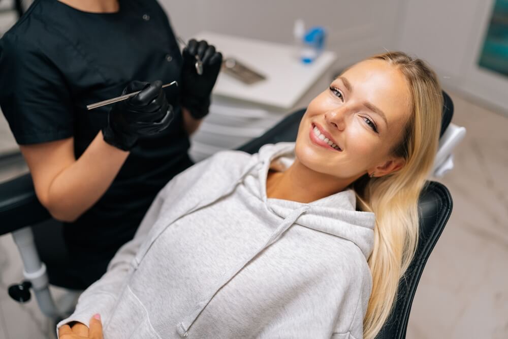 charming young woman patient with perfect white teeth