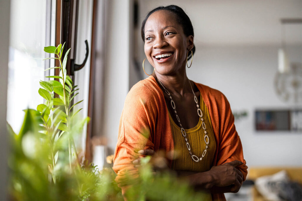 smiling mature woman standing in her apartment