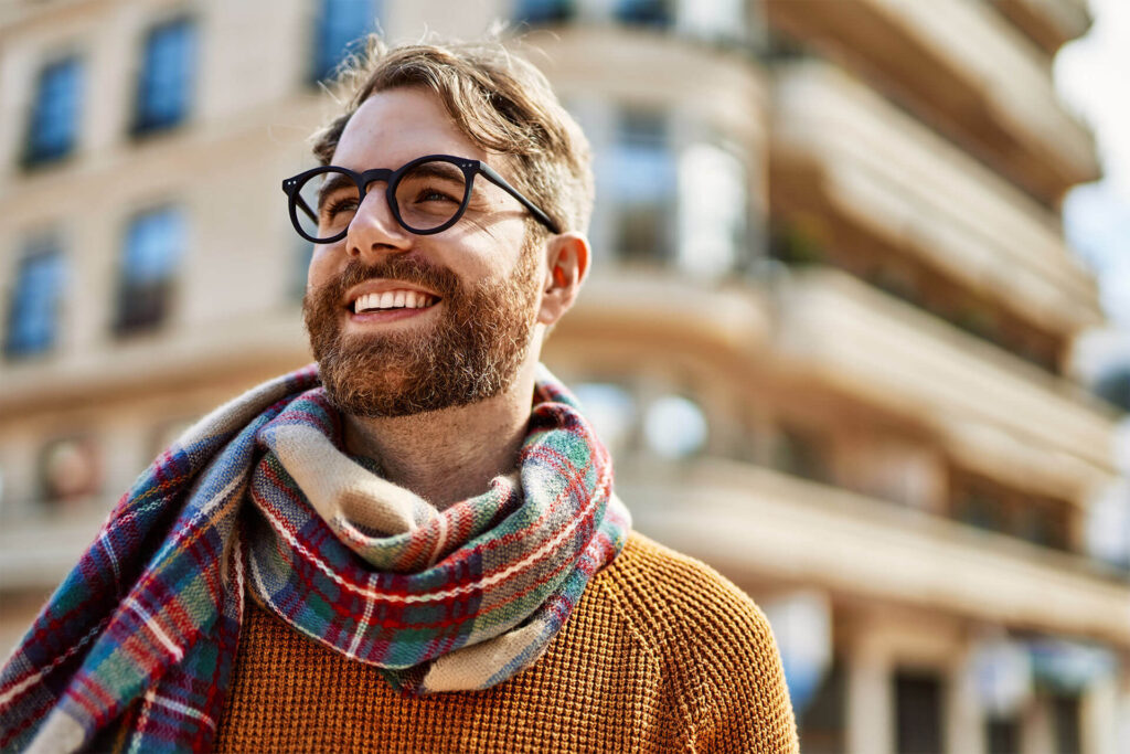 Young man with beard wearing glasses outdoors