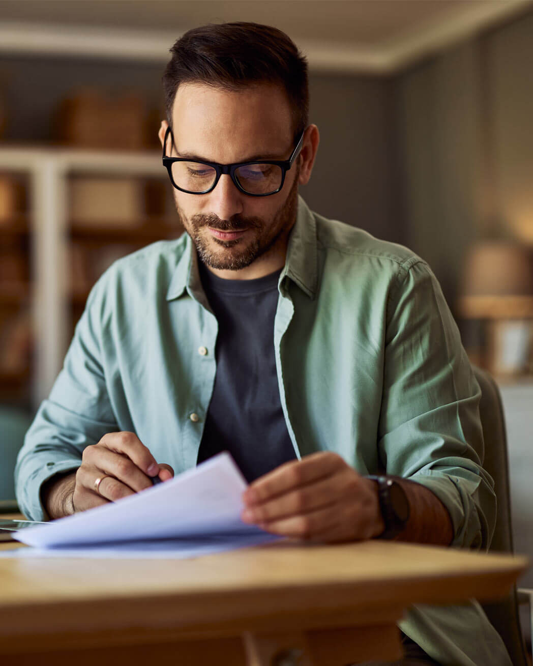 A focused male reading papers