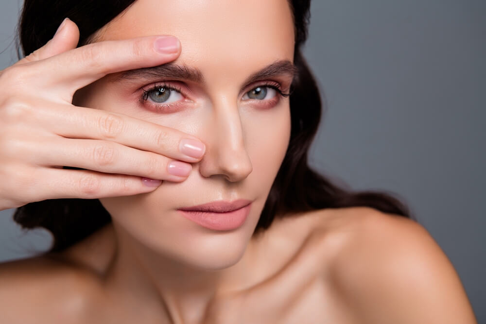 woman touch eyes with fingers