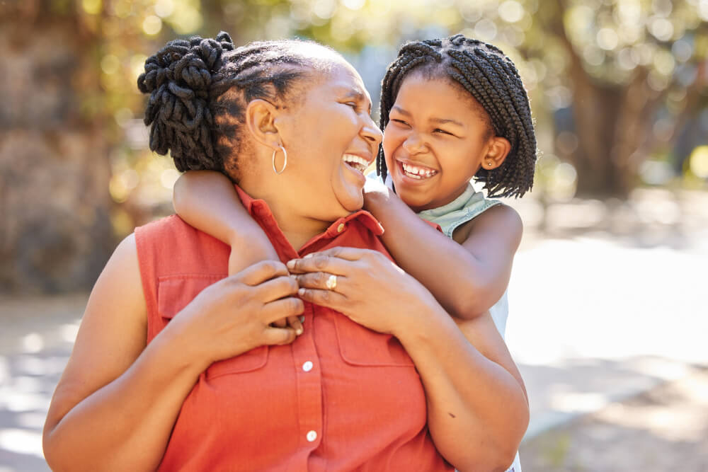 senior woman and child laughing in park