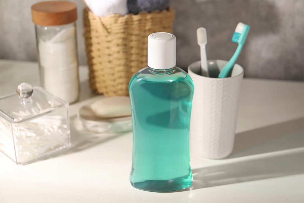 Bottle of mouthwash and toothbrushes