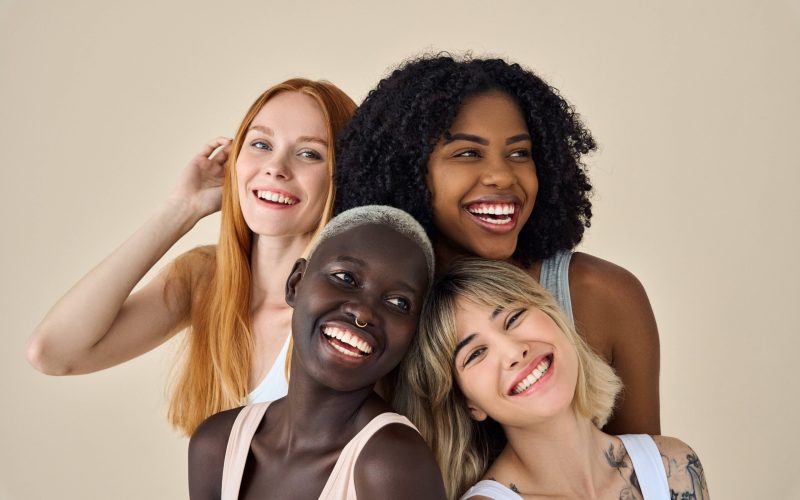 Happy positive cool diverse young women, four smiling multiethnic beauty faces models gen z