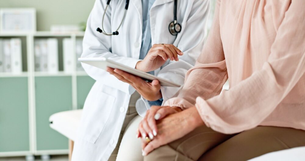 Clinic, tablet and hands of doctor with patient for consulting, medical service and help in hospital