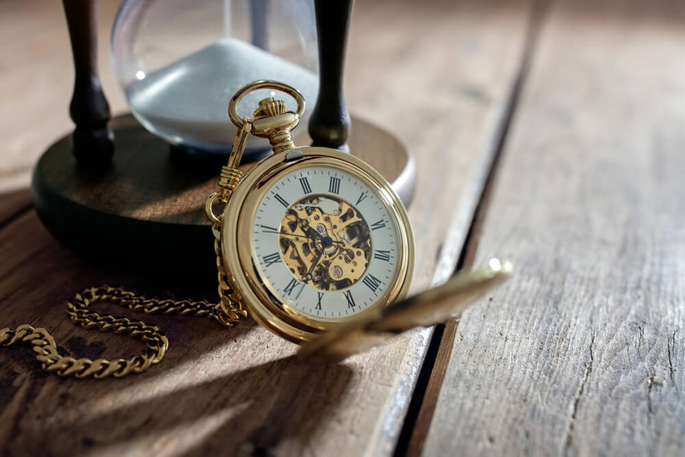 Vintage pocket watch and hour glass