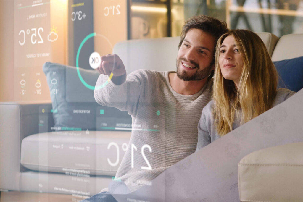 Couple sitting on the sofa controls all the functions of the house