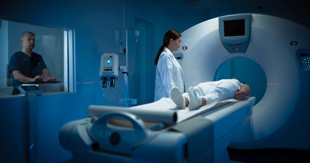 Female Radiologist and Male Doctor Control and Monitor MRI or CT Scan with Female Patient
