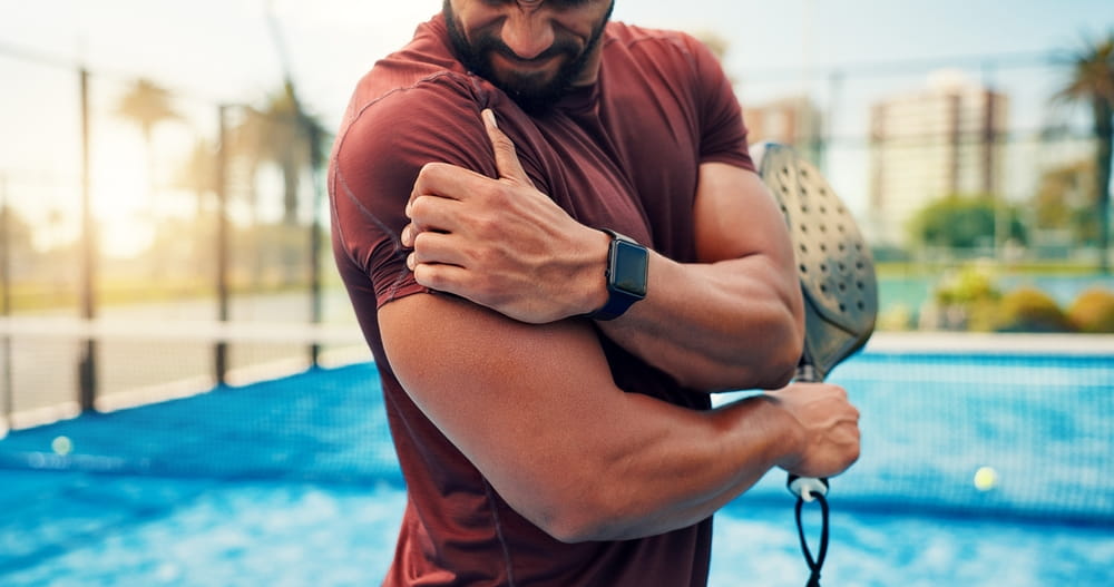 Athlete, man and shoulder pain on padel court from fitness, match accident and muscle sprain