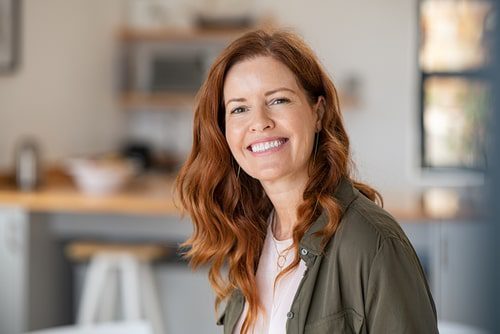 Successful middle aged woman at home smiling