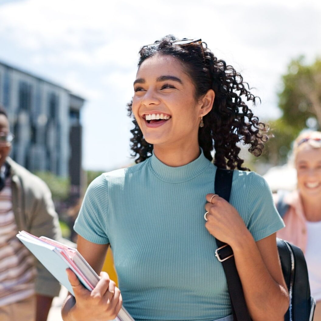 Happy girl with friends at university