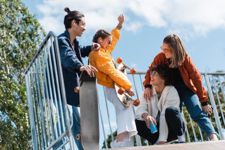 excited woman showing win gesture near skaters