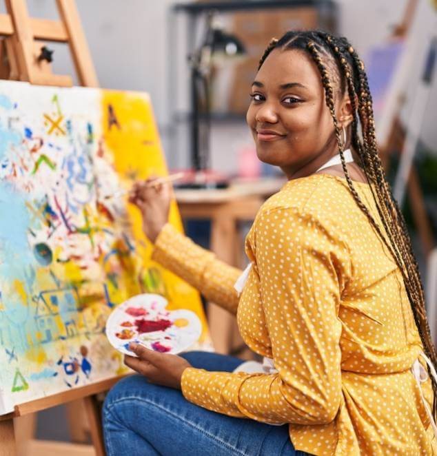 African american woman artist smiling confident drawing at art studio